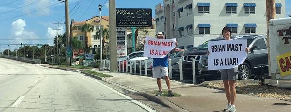 Protestors outside of Brian Mast HQ in Stuart on Saturday, demanding he return donations from Big Sugar