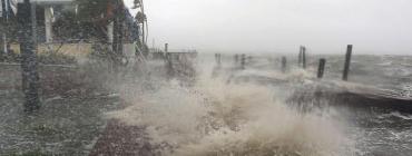 Surf from the Banana River crashes up on a Cocoa Beach dock this morning