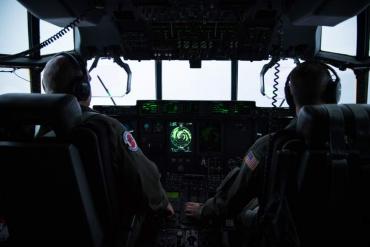 Maj. Kendall Dunn and Lt. Col. Ivan Deroche fly a WC-130J