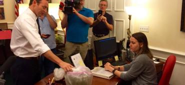 Patrick Murphy presents a secretary in Rick Scott's office with toxic green water Patrick Murphy presents a secretary in Rick Scott's office with toxic green water