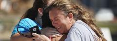 Neighbors hug Thursday in Mexico Beach. Their homes were heavily damaged by the storm. Neighbors hug Thursday in Mexico Beach. Their homes were heavily damaged by the storm.