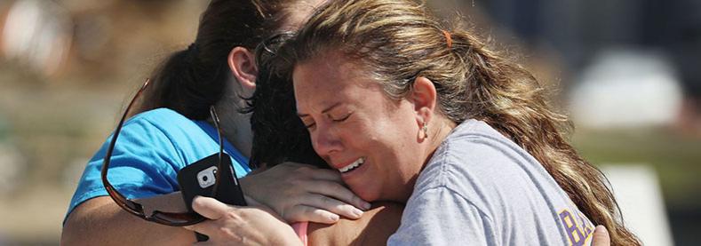 Neighbors hug Thursday in Mexico Beach. Their homes were heavily damaged by the storm.