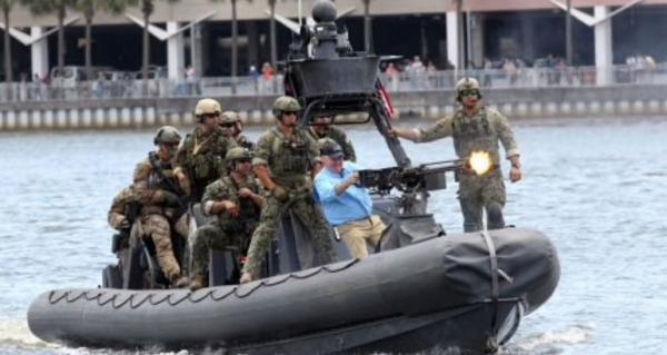 Bob Buckhorn fires blanks from a .50-caliber machine gun from a rigid hull inflatable boat. Bob Buckhorn fires blanks from a .50-caliber machine gun from a rigid hull inflatable boat.